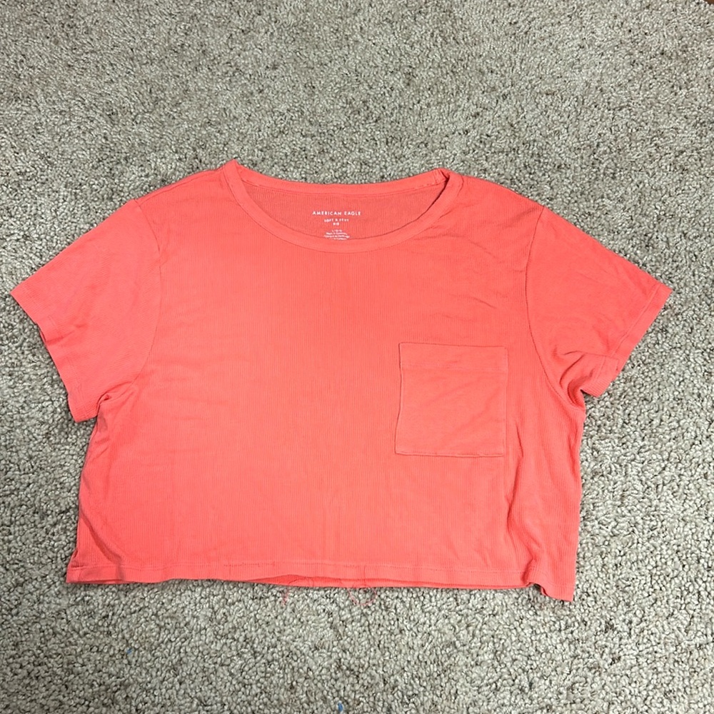 This crop top is from American Eagle, it’s a size L, and it’s coral pink